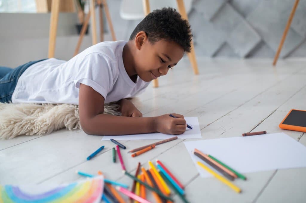 Child using critical thinking skills to draw a leaf from observation